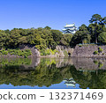 The castle tower reflected in the blue sky and moat water 132371469
