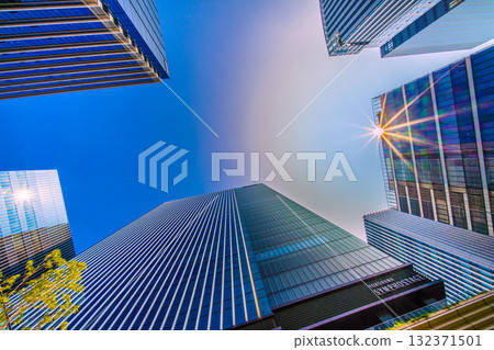 A rare sight in the cityscape of Yokohama, Japan. A mysterious sight of a pale ring surrounding the sun... View of the skyscrapers in front of Shin-Takashima Station A rare sight in the cityscape of Yokohama, Japan. A mysterious sight of a pale ring surrounding the sun... View of the skyscrapers in front of Shin-Takashima Station 132371501
