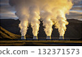 Steam rises from geothermal power plant in a mountainous landscape at sunset 132371573