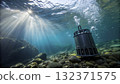 Stunning underwater view of a device resting on the rocky bottom as sunlight filters  132371575
