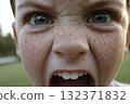 A close-up portrait of a screaming red-haired freckled boy 132371832