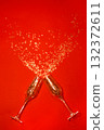 New Year's, confetti spilling out of champagne glasses on a red background 132372611