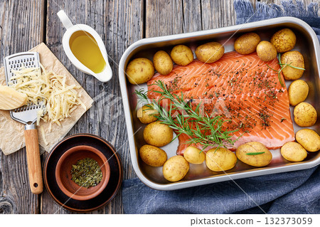 raw salmon fillet with baby potato in baking dish raw salmon fillet with baby potato in baking dish 132373059