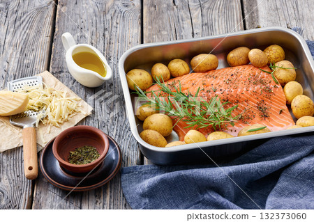 raw salmon fillet with baby potato in baking dish 132373060