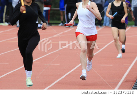 Relay Race at Track Meet With Runners in Action 132373138