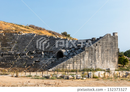 Roman Theatre of Patara ancient city. A historic stone amphitheater ruins Roman Theatre of Patara ancient city. A historic stone amphitheater ruins 132373327