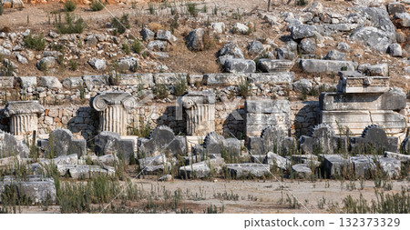 Weathered ancient ruins reveal crumbling colonnade fragments 132373329