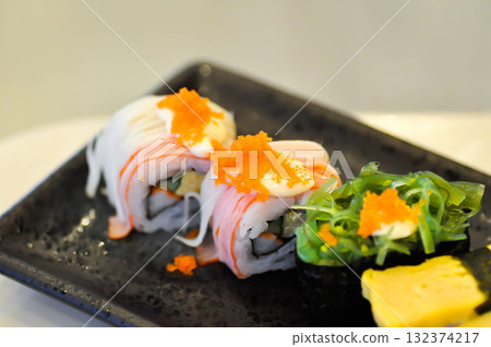 sushi or egg sushi , rice topped with egg and shrimp sushi or steam egg roll and seaweed roll sushi or egg sushi , rice topped with egg and shrimp sushi or steam egg roll and seaweed roll 132374217