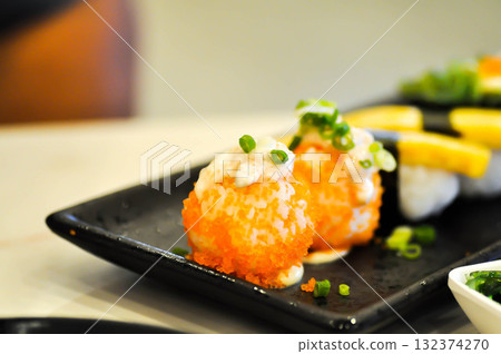 shrimp egg rolls or rice topped with fish or Japanese rolls 132374270