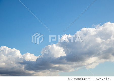 Bright sky with fluffy white clouds creating a picturesque atmosphere in a tranquil outdoor setting Bright sky with fluffy white clouds creating a picturesque atmosphere in a tranquil outdoor setting 132375159