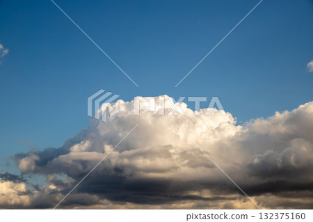 Beautiful fluffy clouds under a clear blue sky during mid-afternoon Beautiful fluffy clouds under a clear blue sky during mid-afternoon 132375160