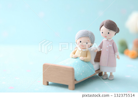 An elderly person lying in bed and a kind nurse (3D felt) 132375514
