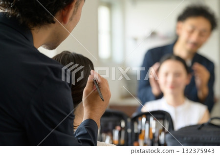 Man applying make-up to a woman Man applying make-up to a woman 132375943