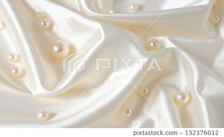 Background of pearls scattered on white satin fabric 132376012