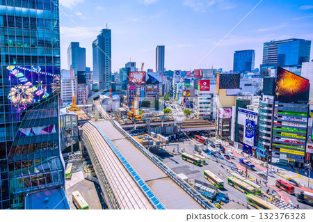A view of the Shibuya district of Tokyo, Japan. In the foreground is Shibuya Station on the Tokyo Metro Ginza Line. Shibuya Scramble Crossing can be seen in the background. 132376328