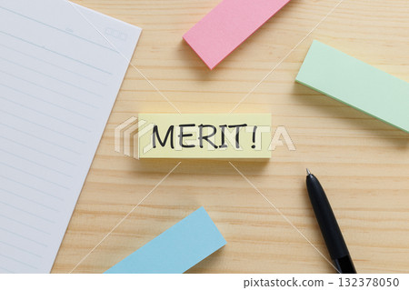 A sticky note on the desk that says MERIT! A sticky note on the desk that says MERIT! 132378050