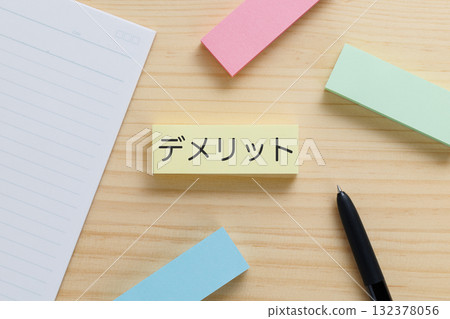A sticky note on the desk with the word "disadvantage" written on it 132378056