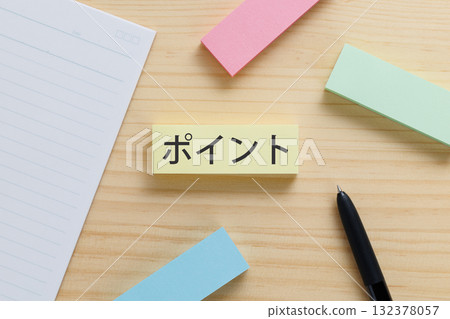 A sticky note with the word "points" written on it on the desk 132378057