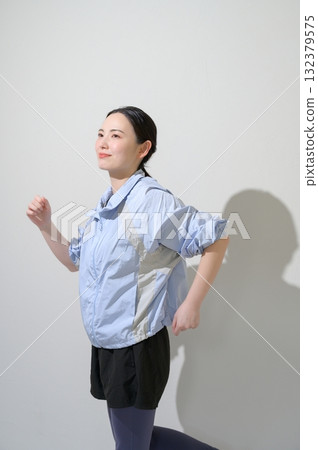 A woman playing sports on a white background A woman playing sports on a white background 132379575