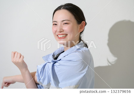 Japanese woman stretching on white background Japanese woman stretching on white background 132379656