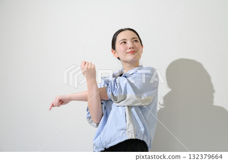 Japanese woman stretching on white background 132379664