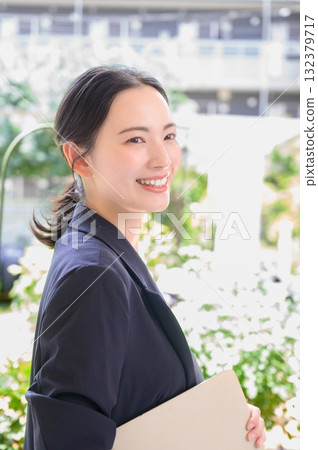 Japanese woman with a laptop in the office Japanese woman with a laptop in the office 132379717