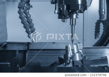 The 5-axis CNC milling machine cutting the aluminum automotive part with indexable tool in the light blue tone. The 5-axis CNC milling machine cutting the aluminum automotive part with indexable tool in the light blue tone. 132379746