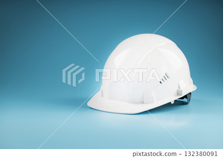Construction worker's safety helmet white on blue background Construction worker's safety helmet white on blue background 132380091