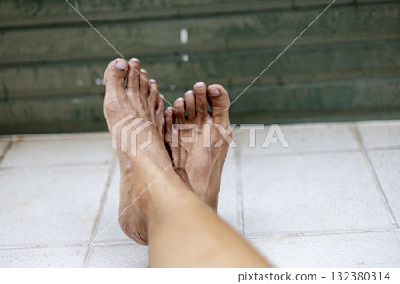 Barefoot Woman Standing On Tiles, Relaxed feet rest on weathered old tiles, showcasing a cozy rustic charm, perfect for promoting vintage flooring restorations. 132380314