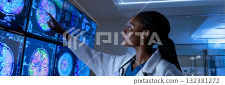A doctor in a white coat and glasses intently reviews digital diagnostic screens in a dim hospital room, concentrating on brain scans during late hours of a shift, banner A doctor in a white coat and glasses intently reviews digital diagnostic screens in a dim hospital room, concentrating on brain scans during late hours of a shift, banner 132381272