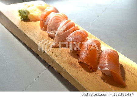 salmon Sushi Japanese food with wasabi dipping soy sauce on long wooden plate salmon Sushi Japanese food with wasabi dipping soy sauce on long wooden plate 132381484