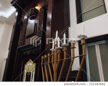 Hanukkah menorah with unlit candles inside a synagogue 132382662