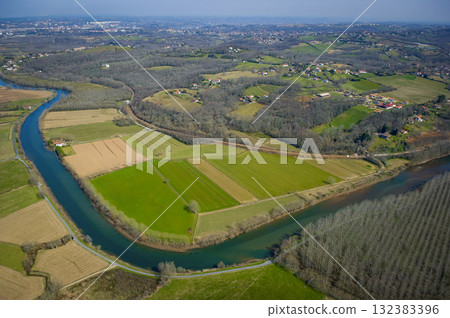 Scenic view of the Nive River and surrounding fields near Villefranque Scenic view of the Nive River and surrounding fields near Villefranque 132383396