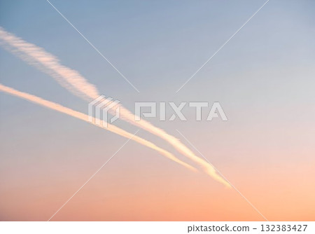Twin Contrails Across Pastel Sunset Sky 132383427