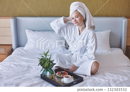 Happy Girl with a Cup of Coffee. Home Style Relaxation Woman Wearing Bathrobe and Towel after Shower. Spa Good Morning Happy Girl with a Cup of Coffee. Home Style Relaxation Woman Wearing Bathrobe and Towel after Shower. Spa Good Morning 132383532
