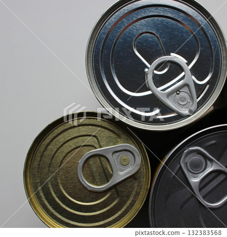 Top Lids of Three Variety Tin Cans Isolated on White Table Stock Photo. Pull Rings of Aluminum Containers with Preserved Food   132383568