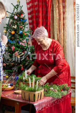 Senior old woman crafting. Make Christmas tree wreath. Home decoration in December DIY 132383817