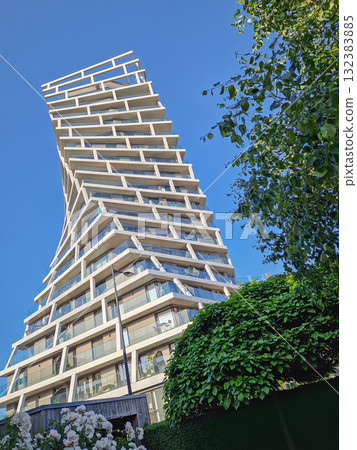 Tour Alta in Le Havre, France, a striking residential skyscraper with modern architecture in unique twisting, helical form. Geometric complexity tower, contemporary urban design Tour Alta in Le Havre, France, a striking residential skyscraper with modern architecture in unique twisting, helical form. Geometric complexity tower, contemporary urban design 132383885