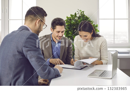 Happy family couple signing paper contract with professional realtor 132383985