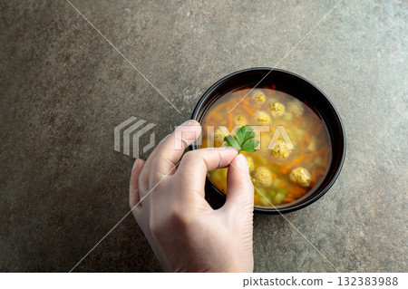 Classic meatball soup with potatoes,  carrot and greens. 132383988