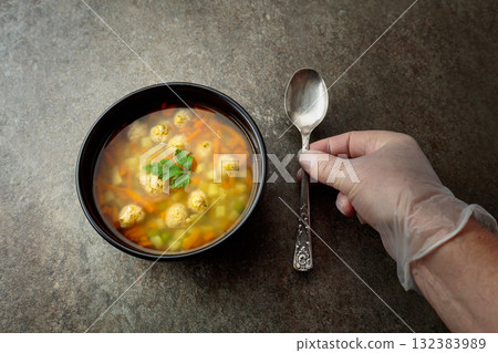 Classic meatball soup with potatoes,  carrot and greens. 132383989