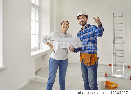 Happy woman together with foreman looking at house or apartment renovation and decoration 132383997