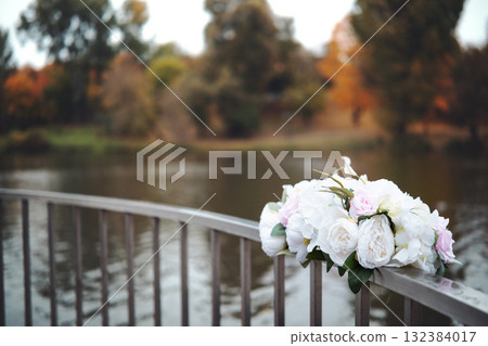 View of beautiful flowers on bridge over water View of beautiful flowers on bridge over water 132384017