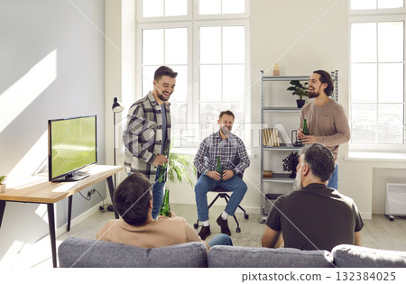 Group of mature bearded friends talking during football match on tv at home with beer. 132384025