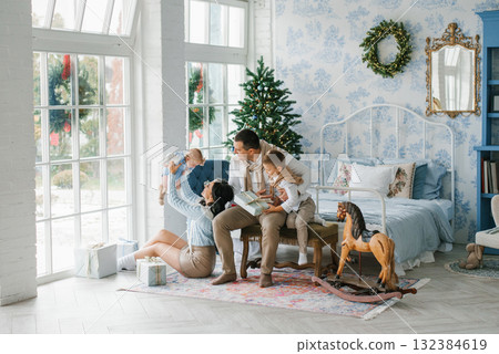 Happy Family Playing With Children In Festive Christmas Interior 132384619