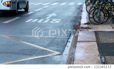 Wet city street with bus lane marking and parked bicycles. Grenoble, France Wet city street with bus lane marking and parked bicycles. Grenoble, France 132385217