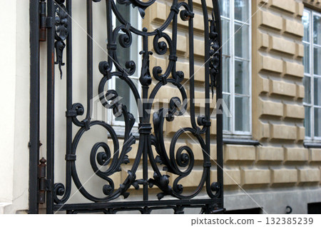 gate and windows of a tenement house, yellow wall 132385239