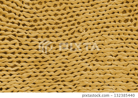 Closeup, macro yellow knitted fabric, cloth texture background with thick yarn pattern surface Closeup, macro yellow knitted fabric, cloth texture background with thick yarn pattern surface 132385440