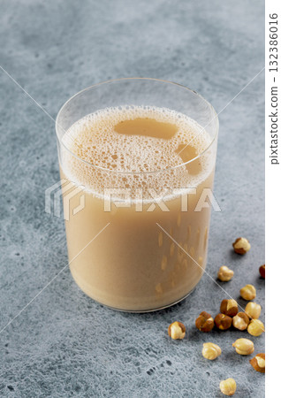 Indian sattu drink with roasted chickpeas, lime wedge on blue background. Protein-rich beverage. 132386016