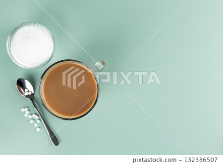A cup of coffee with milk and natural stevia sweetener on a blue background. Top view. Copy space. 132386507